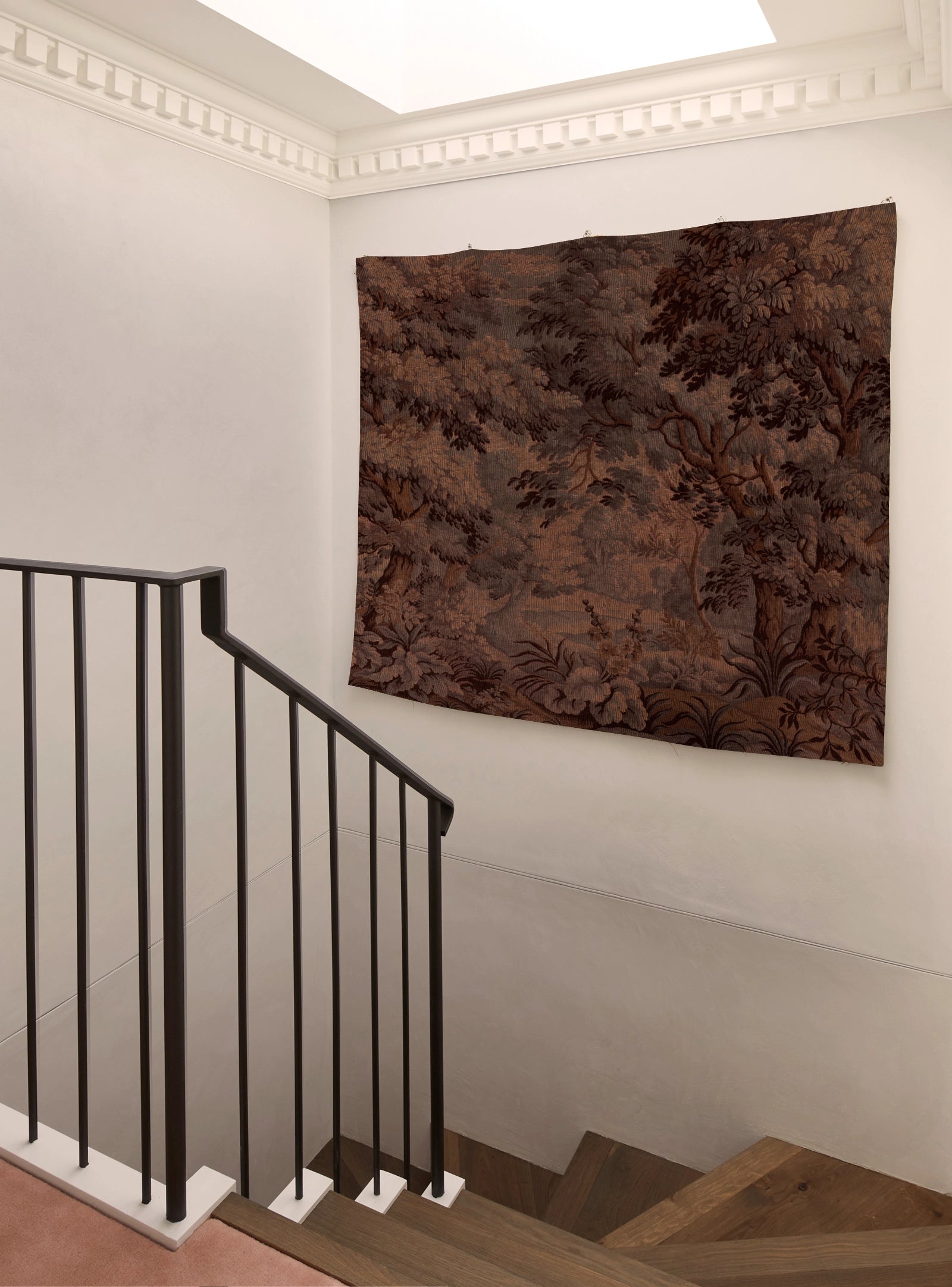 Staircase with a decorative tapestry on the wall
